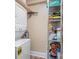 Functional laundry area with a stacked washer and dryer, and shelving for storage at 207 N Dotger Ave # C14, Charlotte, NC 28207