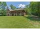Gorgeous view of the home's back exterior showing the multi-level deck and large grassy yard at 260 River Country Rd, Salisbury, NC 28146