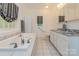 Bright bathroom featuring a soaking tub, white cabinetry, a double sink vanity, and tile flooring at 260 River Country Rd, Salisbury, NC 28146