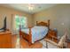 Cozy bedroom with a wooden bed frame, a window view, and warm, inviting decor at 260 River Country Rd, Salisbury, NC 28146
