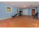 Open bonus room with workout equipment, access to storage, and ample light from two windows at 260 River Country Rd, Salisbury, NC 28146