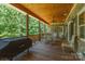 Relax on this home's covered deck with wood ceiling overlooking the natural wooded beauty of the surrounding property at 260 River Country Rd, Salisbury, NC 28146