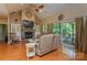 Cozy living room with a stone fireplace, large TV, and sliding glass doors to the outdoor deck at 260 River Country Rd, Salisbury, NC 28146