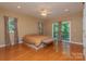 A spacious primary bedroom with hardwood floors, a ceiling fan, and a door leading to an outdoor balcony at 260 River Country Rd, Salisbury, NC 28146