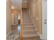 Carpeted staircase with a wooden railing, connecting multiple levels of the home with a visible doorway at 260 River Country Rd, Salisbury, NC 28146