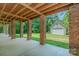 View of the patio area underneath the deck that provides additional outdoor space and includes detached garage at 260 River Country Rd, Salisbury, NC 28146