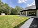 Large backyard with a well-maintained lawn and a covered patio at 4023 Yesteryears Ln, Marshville, NC 28103