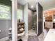 This bathroom features a tiled shower, built in shelves, a window, and leads to a walk-in closet at 4023 Yesteryears Ln, Marshville, NC 28103