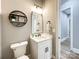 Elegant powder room featuring modern vanity, decorative shelf, and stylish lighting at 4023 Yesteryears Ln, Marshville, NC 28103