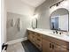 Bathroom featuring double sinks, modern mirrors, and ample cabinet space at 4023 Yesteryears Ln, Marshville, NC 28103