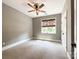 A cozy carpeted bedroom with natural light, a ceiling fan, and neutral paint at 4023 Yesteryears Ln, Marshville, NC 28103