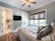 Cozy bedroom featuring a ceiling fan, natural light, and ensuite bathroom for added convenience at 4023 Yesteryears Ln, Marshville, NC 28103