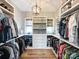 This walk-in closet features custom shelving and hanging storage, with natural light from the window at 4023 Yesteryears Ln, Marshville, NC 28103