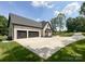 Home with a wide driveway leading to an attached three-car garage at 4023 Yesteryears Ln, Marshville, NC 28103
