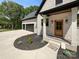 Charming home entrance with a well-manicured flower bed and three-car garage at 4023 Yesteryears Ln, Marshville, NC 28103