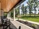 Covered front porch featuring stamped concrete, white pillars, and serene outdoor views at 4023 Yesteryears Ln, Marshville, NC 28103