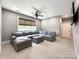 A spacious living room with a large sectional, neutral colors, and a fan at 4023 Yesteryears Ln, Marshville, NC 28103