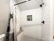 Modern white tiled shower with a built-in seat and recessed niche at 4023 Yesteryears Ln, Marshville, NC 28103