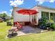 Enjoy outdoor lounging on the back patio with seating, an umbrella, and a fire pit at 409 E 18Th St, Kannapolis, NC 28083