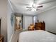 Neutral bedroom with comfortable bed, dresser, chair, and plenty of natural light at 409 E 18Th St, Kannapolis, NC 28083