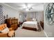 Cozy bedroom featuring a comfortable bed, dresser, and chair, decorated in neutral tones at 409 E 18Th St, Kannapolis, NC 28083