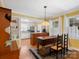 Charming dining area with a farmhouse table, bright yellow walls, and adjacent white kitchen at 409 E 18Th St, Kannapolis, NC 28083