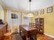 Cozy dining room featuring a unique table, bright yellow walls, and charming decor at 409 E 18Th St, Kannapolis, NC 28083