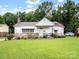 Quaint one-story home with brick accents, tidy lawn, and the American Flag waving out front at 409 E 18Th St, Kannapolis, NC 28083