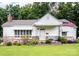 Charming single-story home with a brick foundation, quaint porch, and well-manicured lawn and an American Flag at 409 E 18Th St, Kannapolis, NC 28083