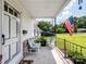 Inviting covered front porch with seating and an American flag, offering a cozy outdoor space at 409 E 18Th St, Kannapolis, NC 28083