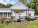 Charming front porch with brick foundation, cozy seating, and American flag waving at 409 E 18Th St, Kannapolis, NC 28083