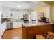 Bright kitchen features granite countertops, stainless steel appliances, and a breakfast bar with stools at 409 E 18Th St, Kannapolis, NC 28083
