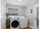 Bright laundry room featuring a modern washer and dryer set with natural light from the window at 409 E 18Th St, Kannapolis, NC 28083