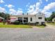 The rear exterior of the home has a quaint patio area with a red umbrella at 409 E 18Th St, Kannapolis, NC 28083