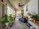 Relaxing sunroom featuring lots of plants, seating area, and ceiling fan at 409 E 18Th St, Kannapolis, NC 28083