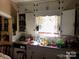 Well-lit kitchen with white cabinets, window over the sink and stainless steel dishwasher at 410 Arthur Ave, Gastonia, NC 28052