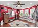 Spacious red bedroom with natural light, wood floors, and custom wall mirrors at 4567 Hickory Grove Rd, Sharon, SC 29742