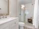 Updated bathroom featuring a glass shower enclosure with modern tile and a sleek white vanity at 4618 Emory Ln, Charlotte, NC 28211