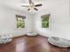 Bedroom with hardwood floors, neutral walls, a ceiling fan, and two windows providing natural light at 4618 Emory Ln, Charlotte, NC 28211