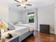 Bedroom with a large window, hardwood floors, and a Tiffany-style lamp on the nightstand at 4618 Emory Ln, Charlotte, NC 28211