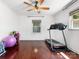 Bright bonus room featuring hardwood floors, a ceiling fan, and a dedicated exercise area at 4618 Emory Ln, Charlotte, NC 28211