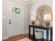 Bright foyer featuring a hardwood floor, interior view front door, and decorator table at 4618 Emory Ln, Charlotte, NC 28211
