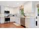 Bright kitchen featuring white cabinets, stainless steel appliances, and hardwood floors at 4618 Emory Ln, Charlotte, NC 28211