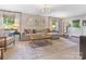 Living room with a sectional sofa, area rug, and a large window offering abundant natural light at 4618 Emory Ln, Charlotte, NC 28211