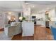 Bright living room with hardwood floors connects to a modern kitchen with white cabinetry and stainless appliances at 4618 Emory Ln, Charlotte, NC 28211
