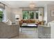 Cozy living room with a chandelier, plush seating, and large windows at 4618 Emory Ln, Charlotte, NC 28211
