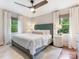 Main bedroom with a fan, white bedding, and a view of the outdoors through the window at 4618 Emory Ln, Charlotte, NC 28211