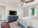 Main bedroom with dark wood floors, a flat-screen TV, and a large window providing natural light at 4618 Emory Ln, Charlotte, NC 28211