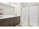 Modern bathroom featuring dual sinks, a spacious glass-enclosed shower, and elegant fixtures at 5008 Calvine Mill Way, Charlotte, NC 28205