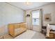 Cozy Bedroom with a wood crib, patterned accent wall, and bright natural light at 5008 Calvine Mill Way, Charlotte, NC 28205